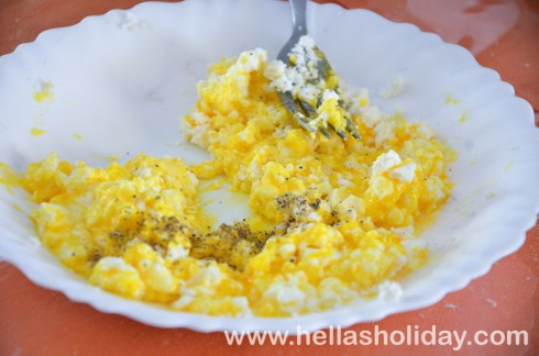 Preparing the pie filling with feta cheese, egg and pepper