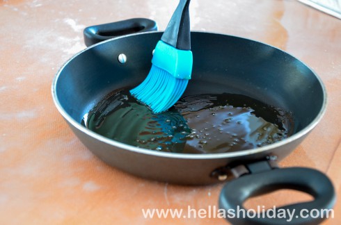 Brushing a frying pan with olive oil