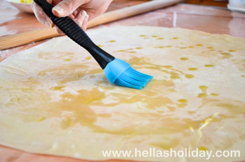 Brushing the filo pastry with olive oil
